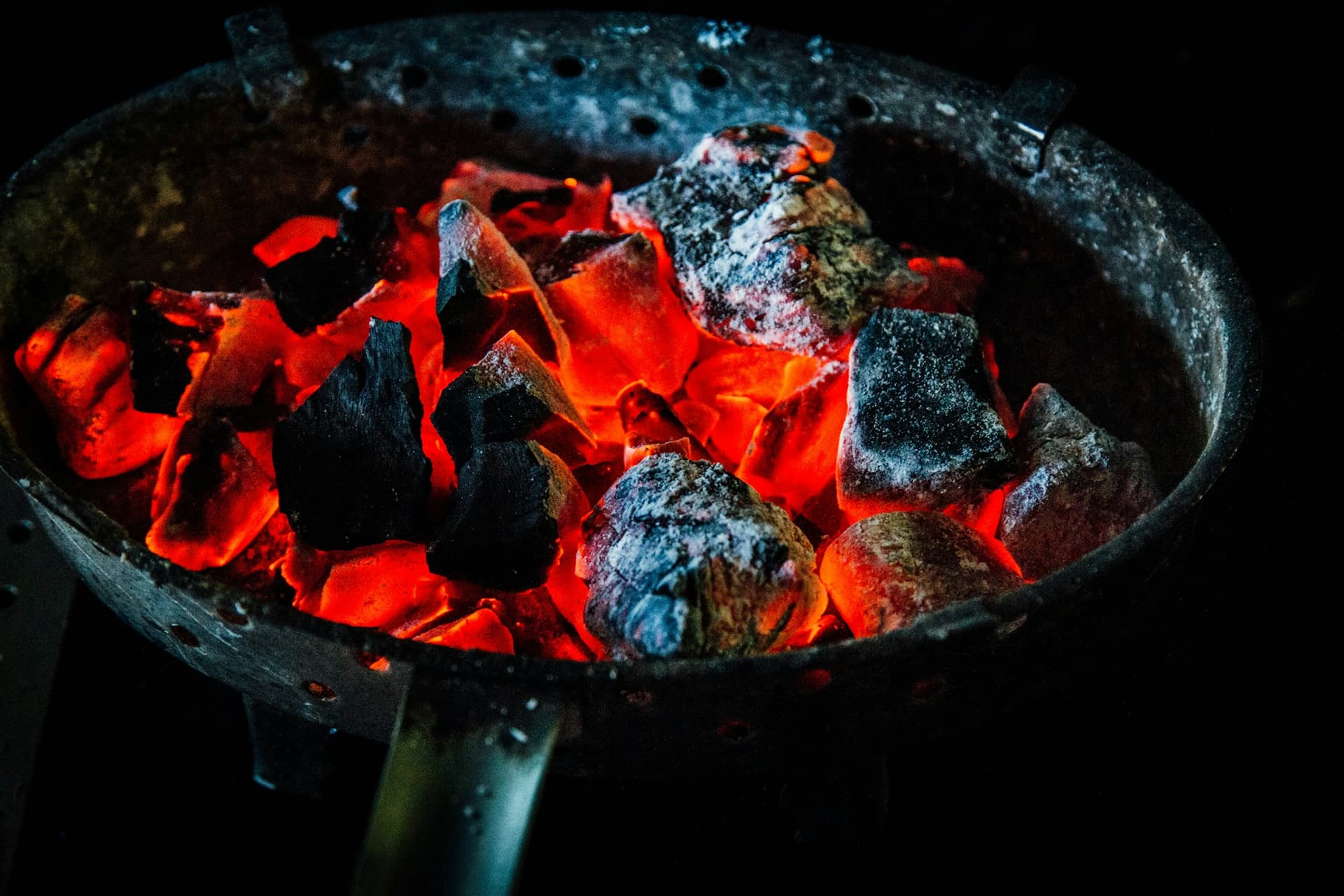 Bed of embers glowing orange in the dark