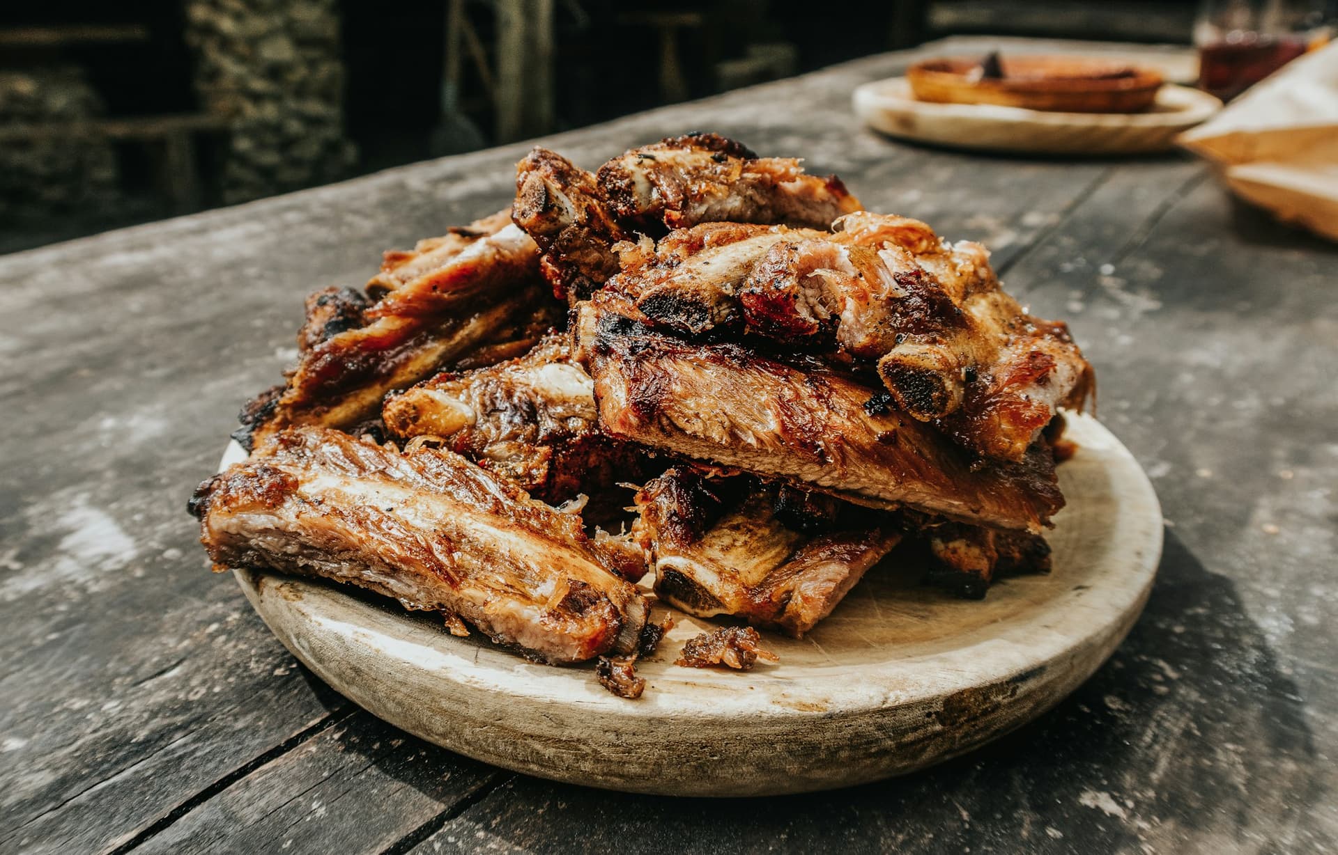 A pile of smoked ribs on a board, ready for a crowd